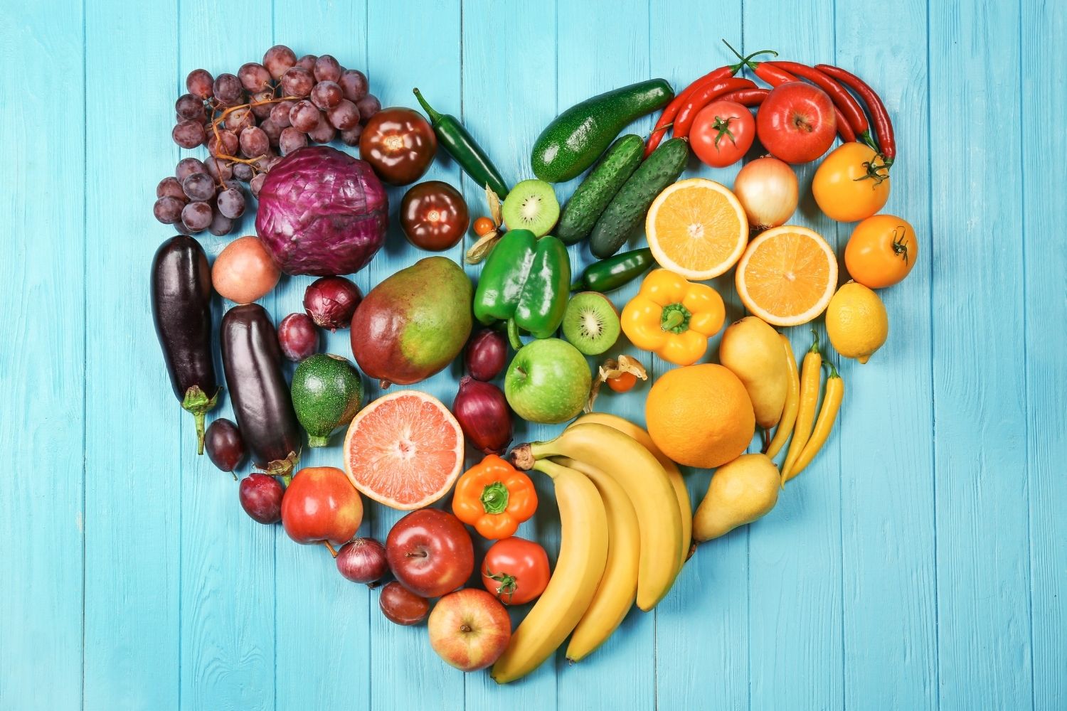 A variety of fruit and vegetables arranged in a heart shape